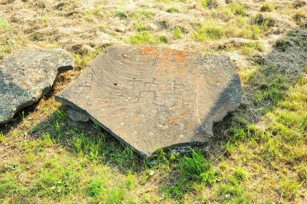 istock A large flat stone with ancient cave paintings depicting human figures. 1459496327