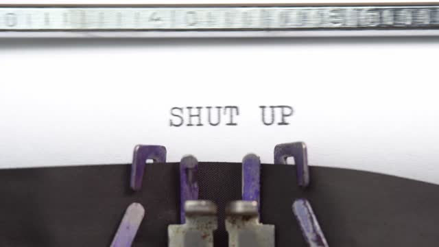 Shut up phrase closeup being typing and centered on a sheet of paper on old vintage typewriter mechanical