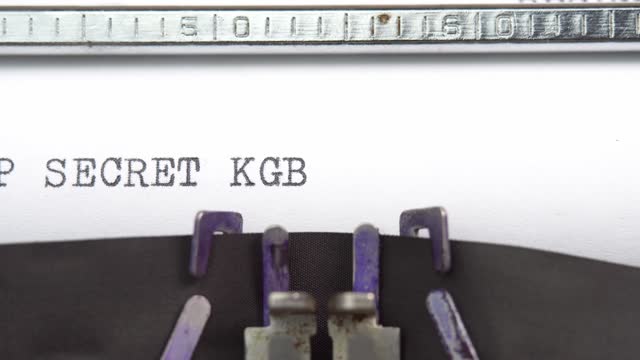 Top secret KGB phrase closeup being typing and centered on a sheet of paper on old vintage typewriter mechanical