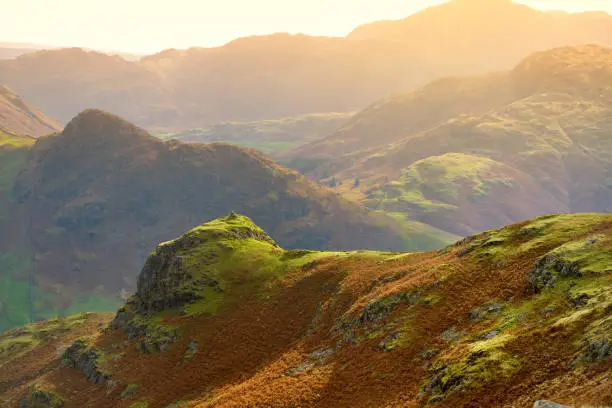 Sunset view of the Lake District, famous for its glacial ribbon lakes and rugged mountains. Popular vacation destination in Cumbria, North West England. Tourist attractions in Great Britain.