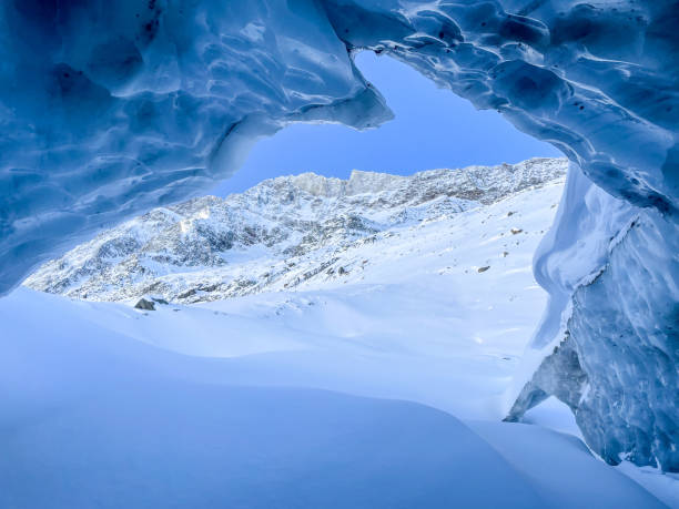 istock Ice cave in the snowcapped mountain range in Switzerland 1459502266