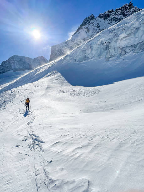 istock One man backcountry skiing on high peaks 1459502327