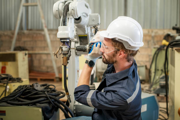istock Engineer factory industry wearing safety uniform work and checking system of the welding robots for welding steel electrical by control system robot automate for industry manufacture concept. 1459502580
