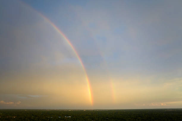 Colorful round rainbow against blue evening sky after heavy thunderstorm.