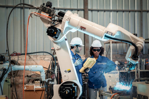 istock Engineer factory industry wearing safety uniform work and checking system of the welding robots for welding steel electrical by control system robot automate for industry manufacture concept. 1459503768