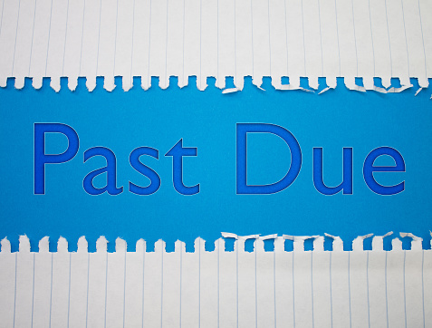 Past Due text with Torn, Crumpled White Paper on colored background.