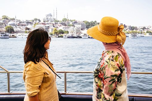 female tourists  on passenger ferry deck, Beyazit, Turkey, enjoying life on the Bosphorus