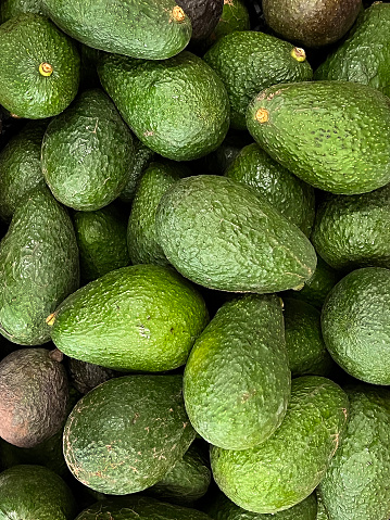 Heap of fresh Hass avocados