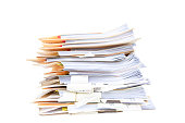 Manila folders stacked overflowing at an office on a white background