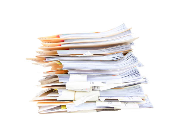 manila folders stacked overflowing at an office on a white background - stack paper document heap imagens e fotografias de stock