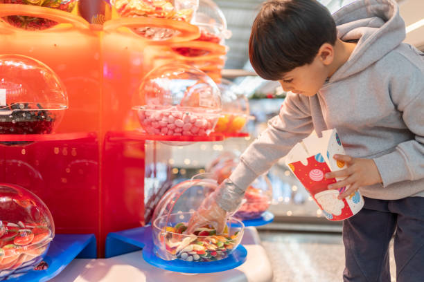Little boy sneakily taking candy from the candy jar.