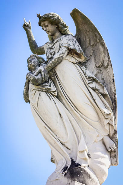 istock Angel Statues in New Orleans Cemetery 1459512355