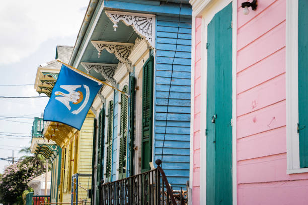 These flags hanging on a iron balcony in New Orleans, represent the USA, the state of Louisiana and the city of New Orleans. The soft morning light give a nice contrast. The New Orleans flag has a large white field that contains three gold fleurs-de-lis and is bordered on the top by a red stripe and from below by a blue stripe.