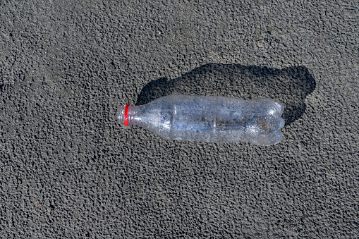 A plastic bottle on a riverbank