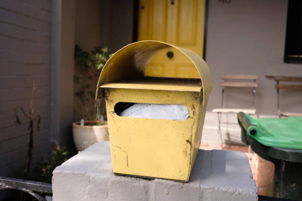 istock Yellow metal mailbox on a wall 1459525238