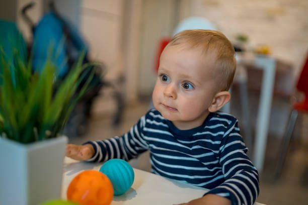 baby is playing with educational toys over white background