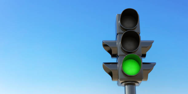 istock Traffic Light on pole, green go signal on clear blue sky background, space for text. 3d render 1459525946