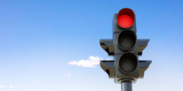 istock Traffic Red Light on pole, red stop signal on blue sky background. Space for text. 3d render 1459525965
