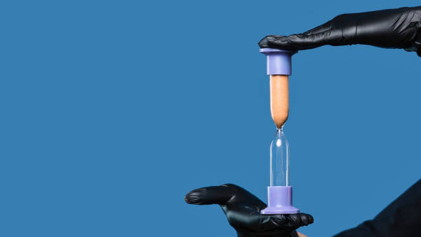 istock Beautician holds sandglass. 1459526554