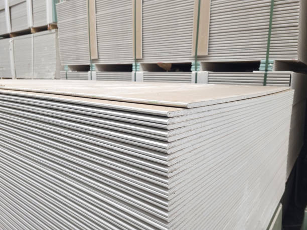 plasterboard sheets stacked in a hardware store. building material. plasterboard sheets stacked in a hardware store. dry gypsum plaster. building material for the arrangement of cladding, partitions, ceilings in buildings. cladding construction equipment photos stock pictures, royalty-free photos & images