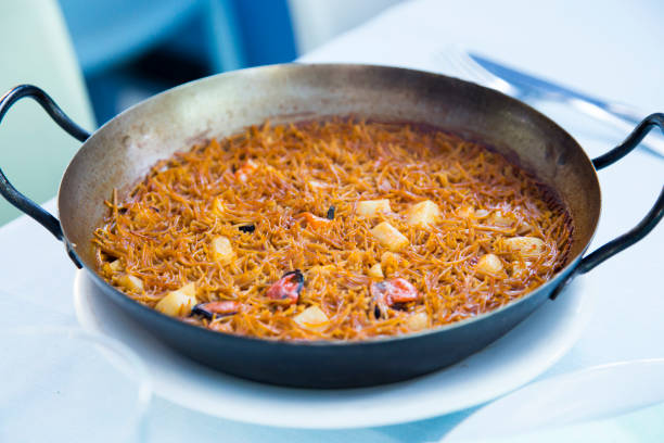 istock Fideua with squid and seafood. Typical Spanish tapa cooked with paella. 1459534104