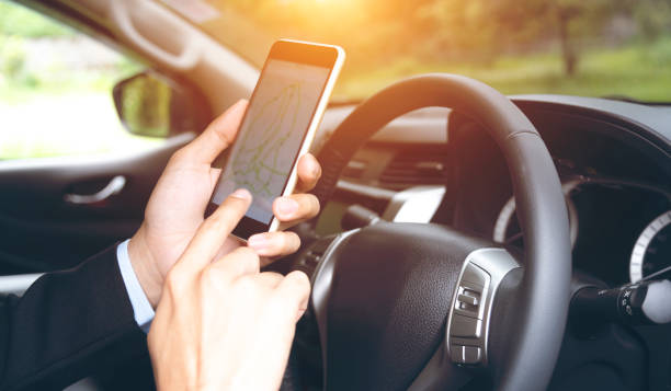 istock businessman using mobile phone to find directions while driving 1459535224