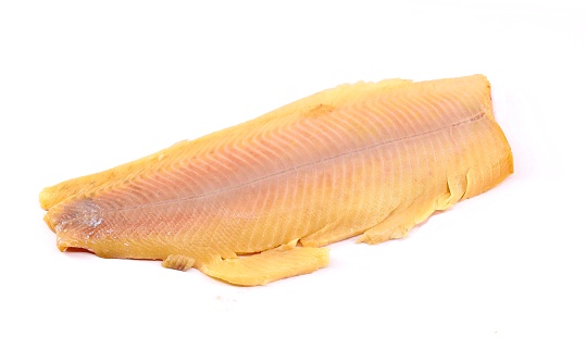 Fillet of skinless smoked rainbow trout on white background.