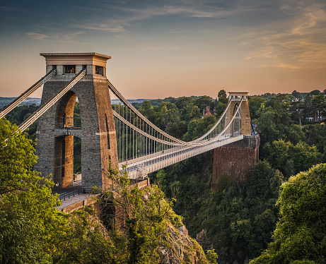 View of beautiful suspension bridge over a gorge at sunset