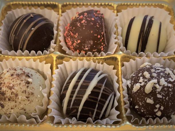 istock Chocolate Candy Truffles in a Gold Gift Box 1459538428