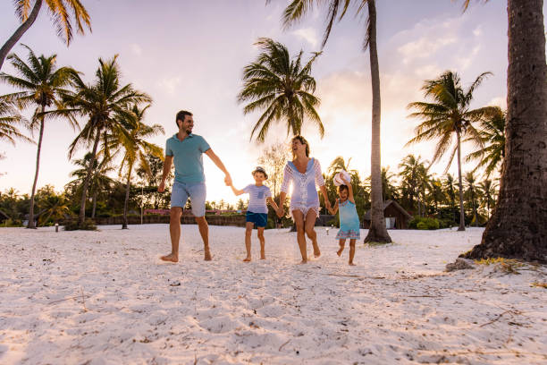 istock Carefree family running on the beach at sunset. 1459538741