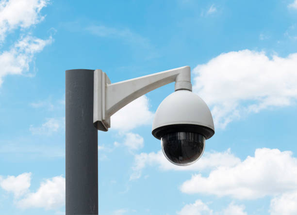 istock Outdoor white CCTV on pole with blue sky background and copy space 1459539951