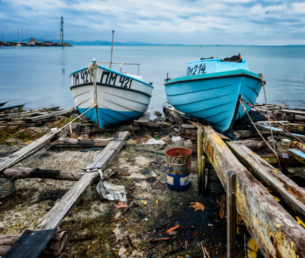 Fishing boats after storm on the shore in Pomorie town. Pomorie town, Bulgaria - December 3, 2022:  Fishing boats after storm on the shore in Pomorie town. Bulgaria, Europe. pomorie stock pictures, royalty-free photos & images