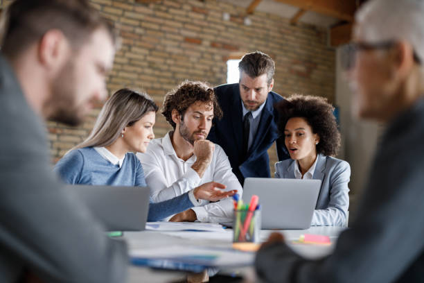 istock Business team brainstorming while working on laptop in the office. 1459541937