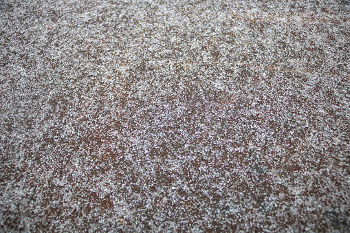 The Textured Snowfall: Fine Snow Laid on a Metal Surface.