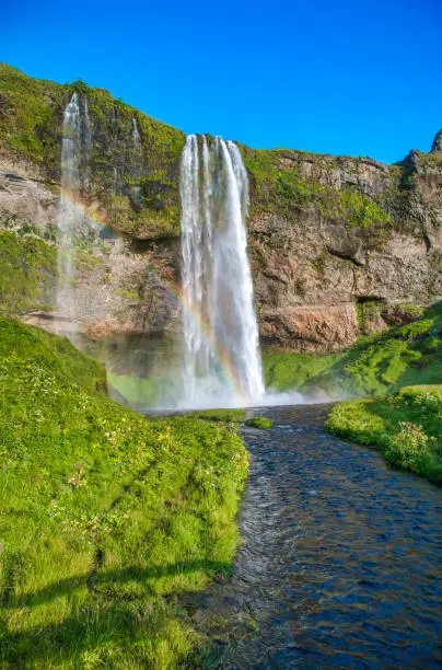 Beautiful view of Seljalandfoss Waterfalls in Iceland on a sunny summer day.