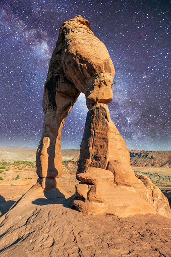 Delicate Arch on a wonderful summer night with milky way, Arches National Park, USA.