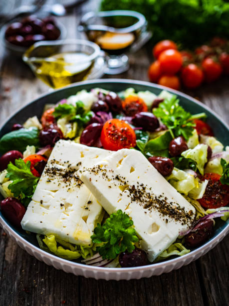 istock Feta cheese salad on wooden table 1459544584