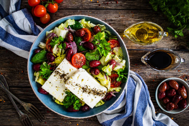 istock Feta cheese salad on wooden table 1459544624