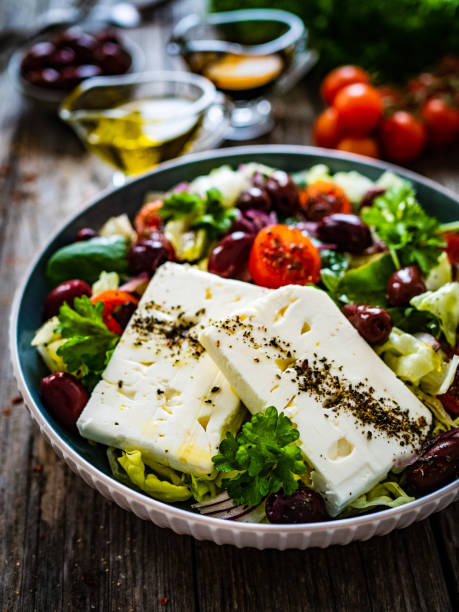 istock Feta cheese salad on wooden table 1459544644