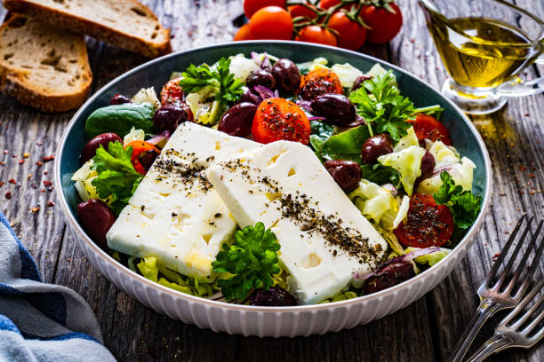 istock Feta cheese salad on wooden table 1459544667