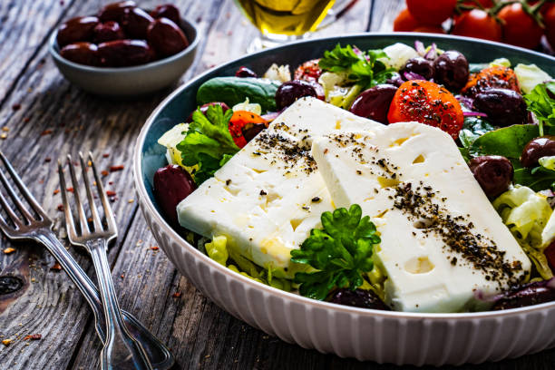istock Feta cheese salad on wooden table 1459544700