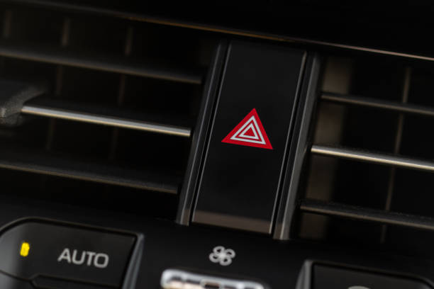 istock Red triangle hazard light button on car dashboard. Car media buttons dashboard. Detail of a modern car controllers. 1459545778