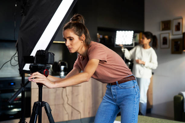 istock Two female women checking camera and lights before recording 1459545909