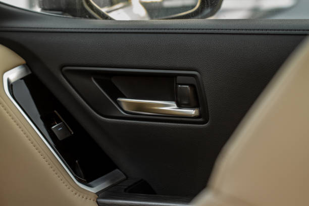 istock Car door handle closeup view. Car interior door panel. Modern car door panel close-up view. 1459546005