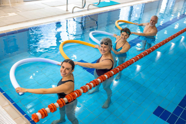 istock Group of seniors having a workout at the swimming pool 1459547516