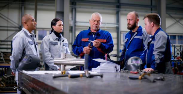 istock Workers discussing in factory 1459548935