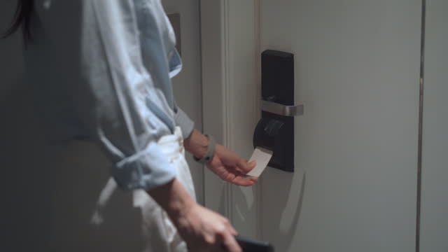 Asian businesswoman using access keycard for opening the security door