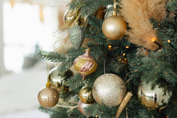 istock Branches of an artificial Christmas tree with gold balls 1459557496