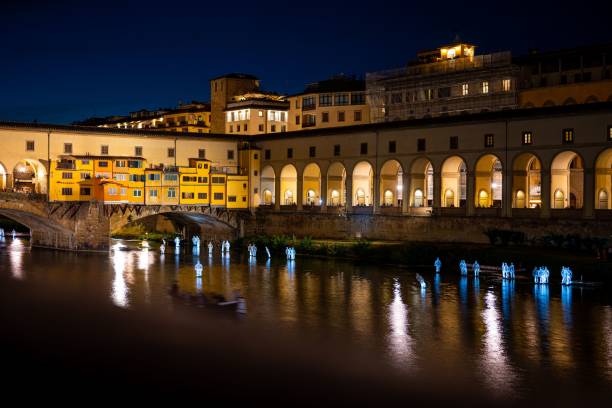 istock Illuminated Ponte Vecchio bridge with the reflection of lights on a water surface at night 1459557730