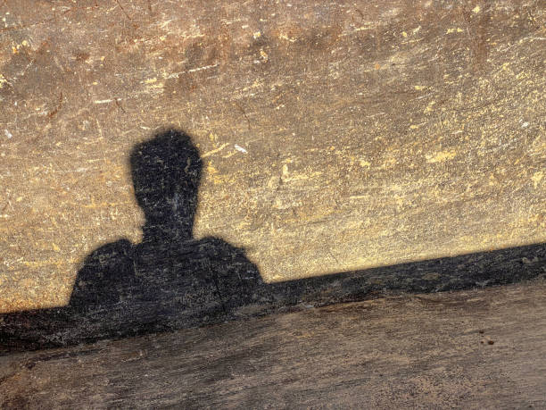 istock Shadow of man projected over bottom of metallic container 1459557967